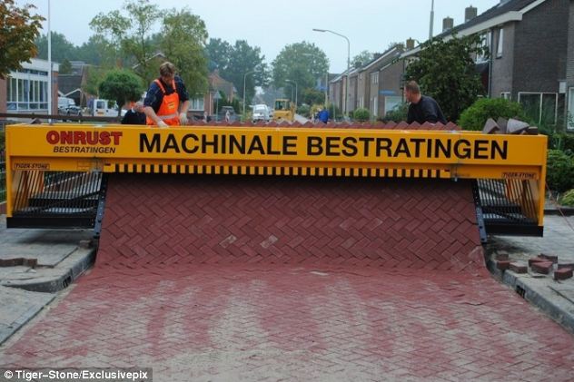 Follow the self-made road: Incredible machine that lays out a carpet of bricks removing back-breaking hard work